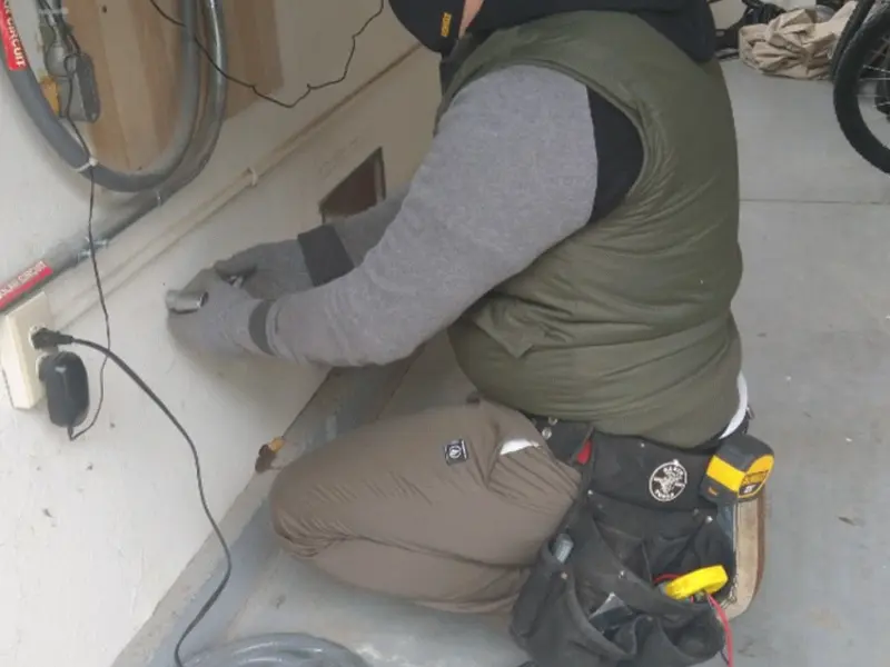 Electrician performing outlet wiring in a Lakemoor garage